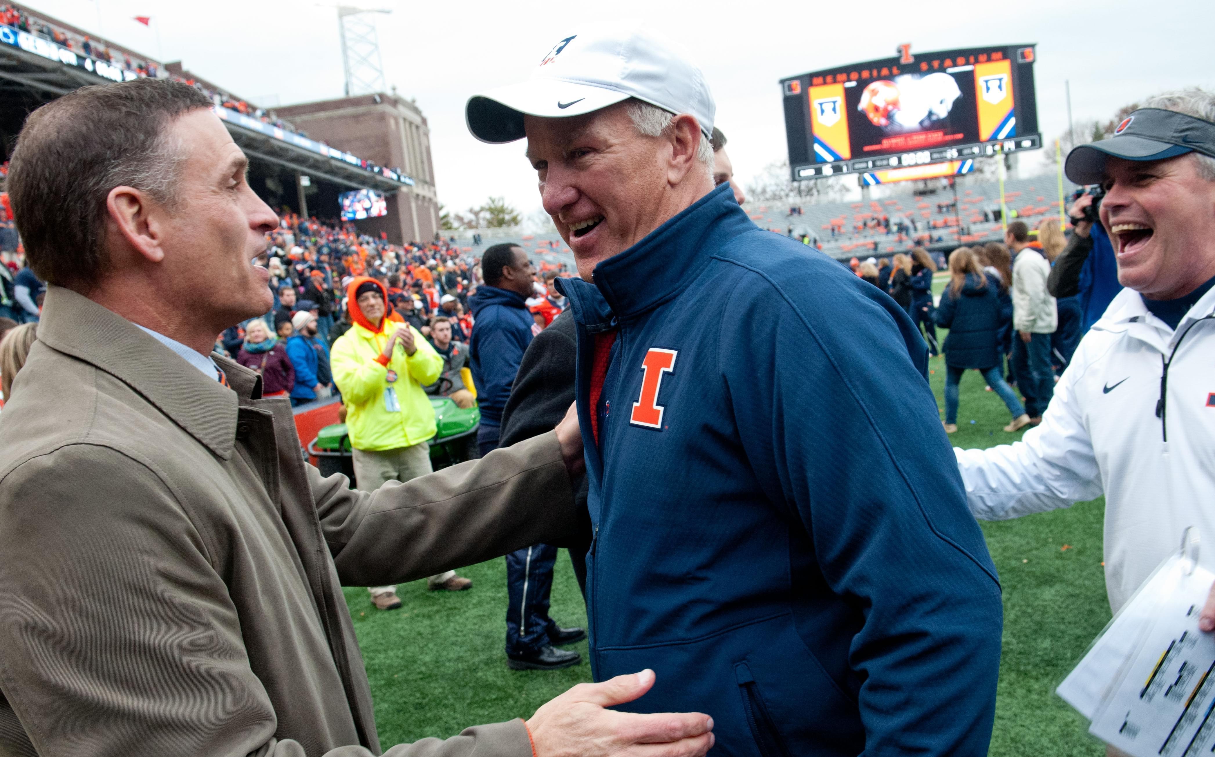 Illinois athletic director Mike Thomas greets offensive coordinator Bill Cubit and head coach Tim Beckman after beating Penn State on Nov. 22, 2014, at Memorial Stadium in Champaign. 