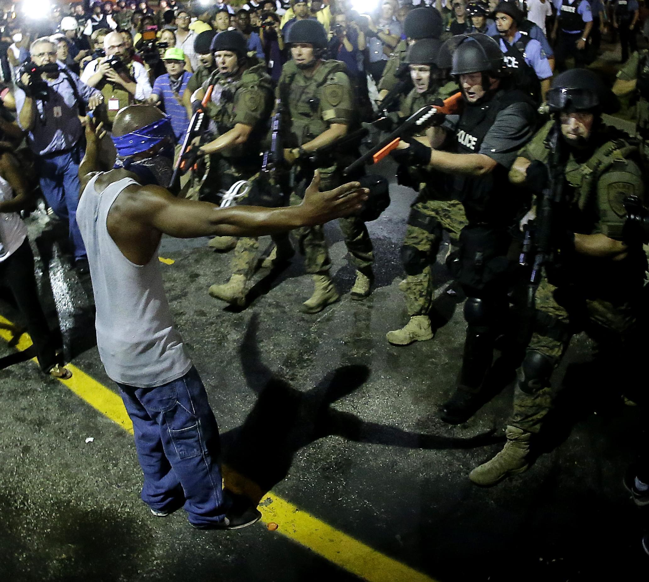A black male is arrested by police during a protest following the shooting of unarmed, black teenager Michael Brown in Ferguson, MO.