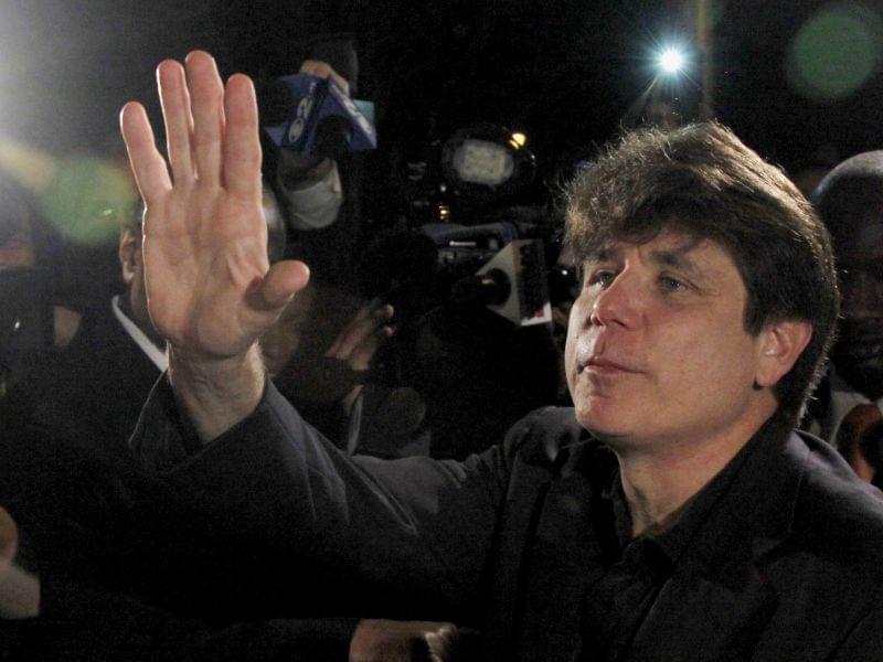 In this March 15, 2012 file photo, former Illinois Gov. Rod Blagojevich waves as he departs his Chicago home for Littleton, Colo., to begin his 14-year prison sentence on corruption charges.