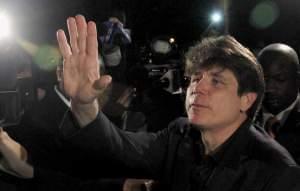 In this March 15, 2012 file photo, former Illinois Gov. Rod Blagojevich waves as he departs his Chicago home for Littleton, Colo., to begin his 14-year prison sentence on corruption charges.