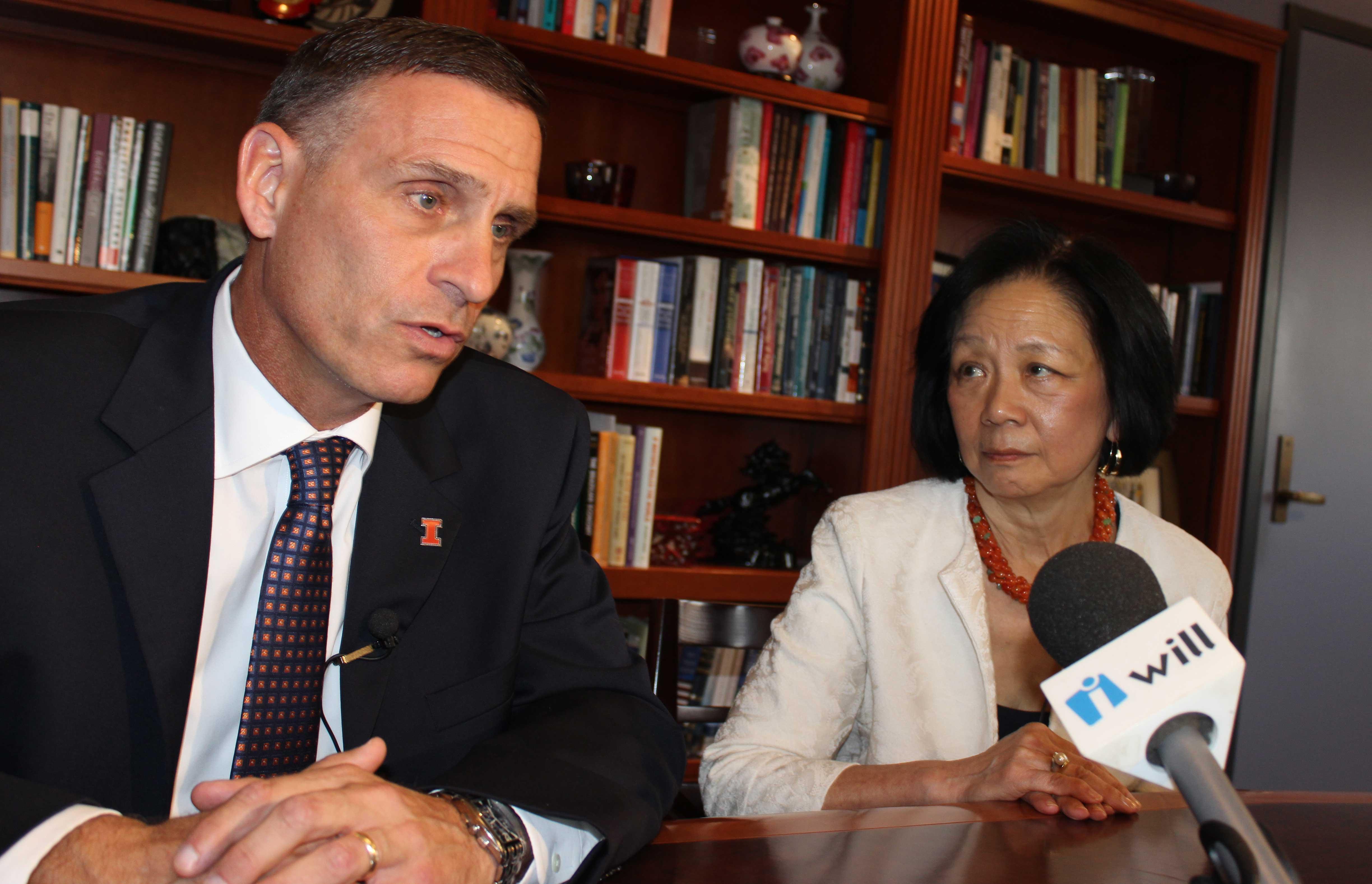 U of I Athletic Director Mike Thomas and Urbana Chancellor Phyllis Wise address reporters in her campus office in Champaign Monday.