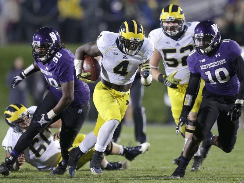 In this Nov. 8, 2014 file photo Michigan running back De'Veon Smith runs against Northwestern during a game in Evanston, IL.