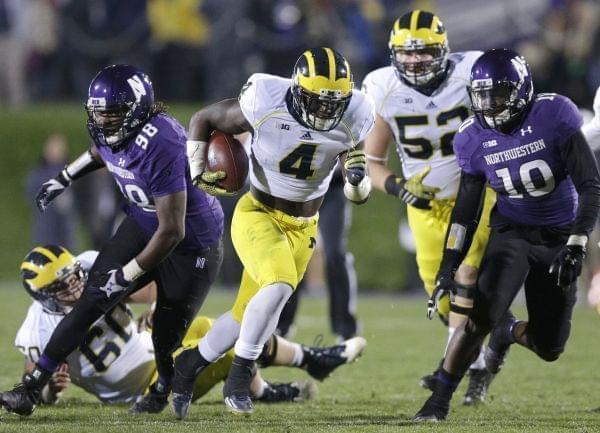 In this Nov. 8, 2014 file photo Michigan running back De'Veon Smith runs against Northwestern during a game in Evanston, IL.