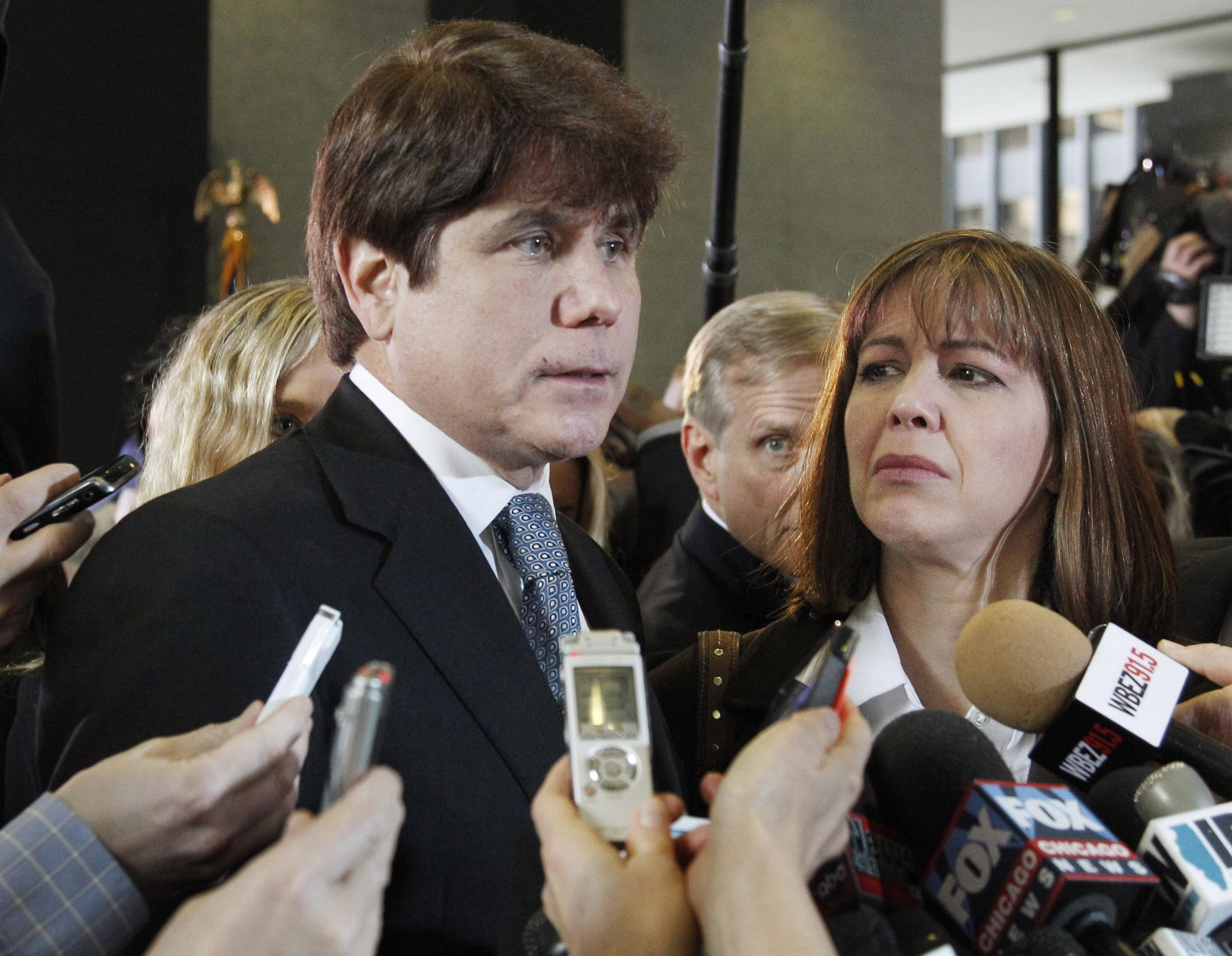 In this Dec. 7, 2011 file photo, former Illinois Gov. Rod Blagojevich, left, speaks to reporters as his wife, Patti, listens at the federal building in Chicago, after Blagojevich was sentenced to 14 years on 18 corruption counts.