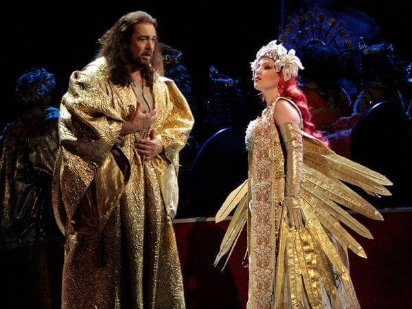 A man and a woman onstage in an opera production