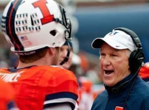 In this Nov. 22, 2014, file photo, new Illinois coach and offensive coordinator Bill Cubit talks to quarterback Reilly O'Toole (4) during a game against Penn State in Champaign, 