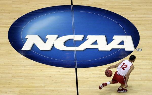 In this March 26, 2014, file photo, Wisconsin's Traevon Jackson dribbles past the NCAA logo during practice at the NCAA men's college basketball tournament in Anaheim, Calif