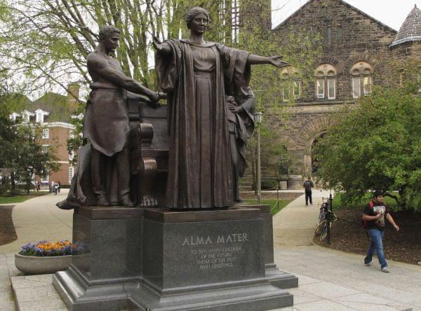 In this April 28, 2014 photo, Students walk past the Alma Mater statue, a landmark on the University of Illinois campus in Urbana.