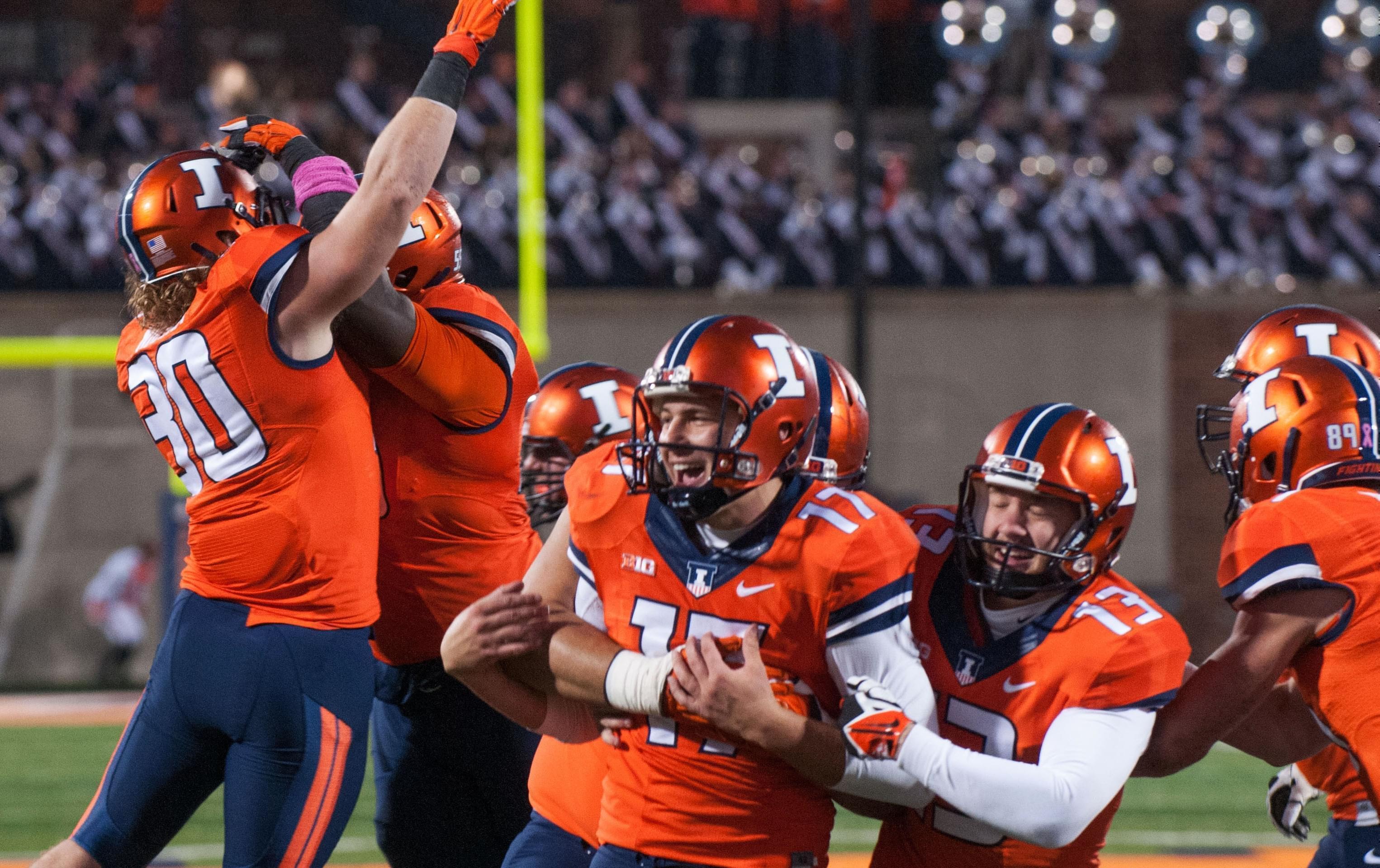 Illinois place kicker Taylor Zalewski is congratulated by teammates after kicking the go ahead extra-point in the closing seconds of Illinois' 14-13 win over Nebraska in Champaign Saturday.