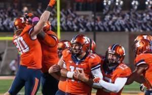 Illinois place kicker Taylor Zalewski is congratulated by teammates after kicking the go ahead extra-point in the closing seconds of Illinois' 14-13 win over Nebraska in Champaign Saturday.