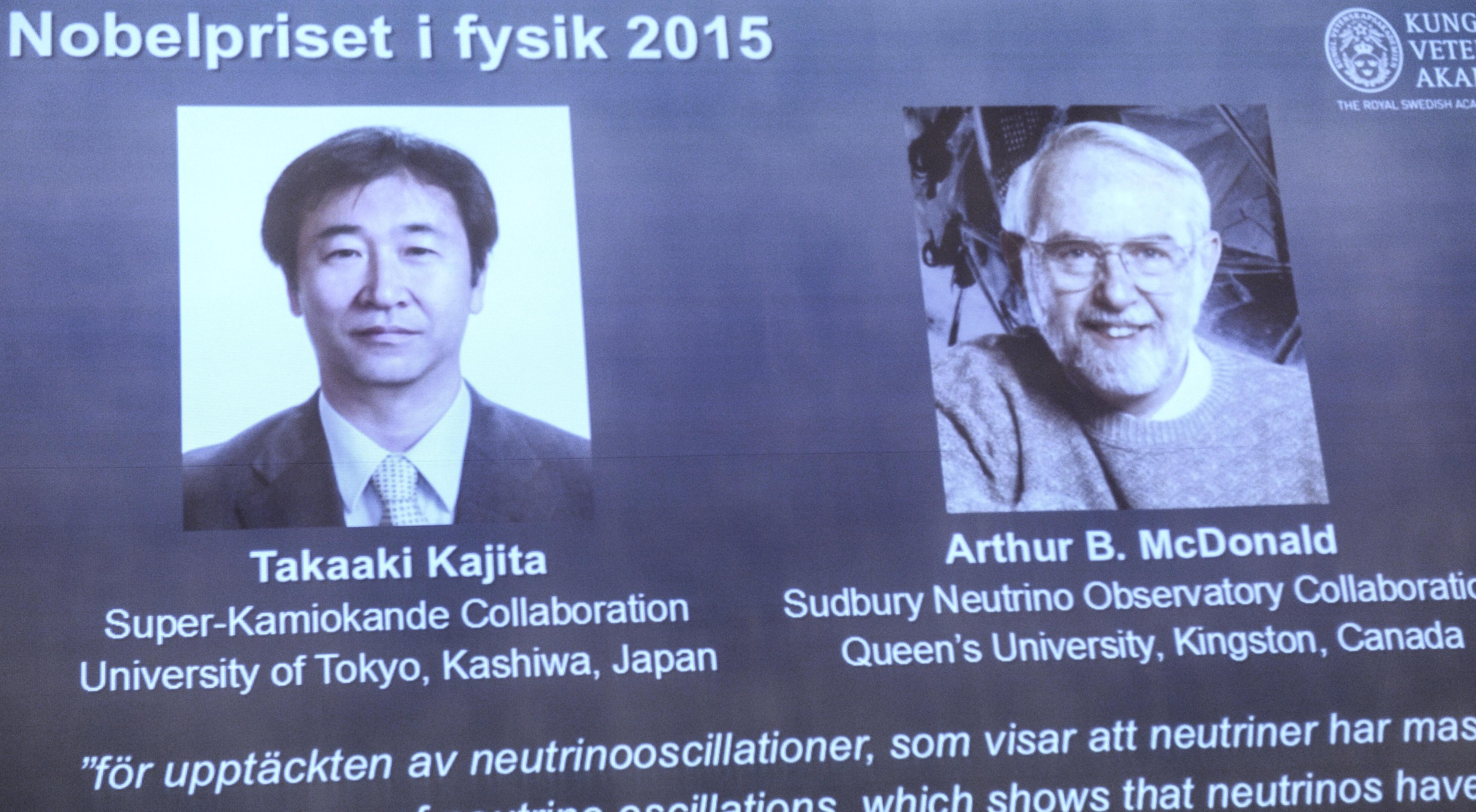 A screen shows the winners as members of the Nobel Assembly announce the winner of the 2015 Nobel Prize in physics, in Stockholm Tuesday