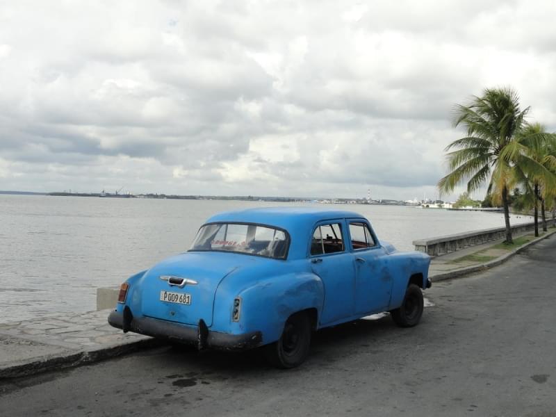 An older blue car.