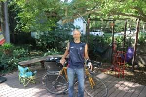 Ray Spooner standing with his bicycle outside his home in Urbana