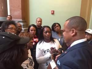 Child-care advocates confront Rep. Ken Dunkin over his decision to go back on a promise to support legislation they favored.