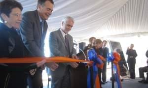 President Timothy Killeen and other dignitaries cut a ceremonial ribbon to open the new solar farm at the University of Illinois Urbana campus.