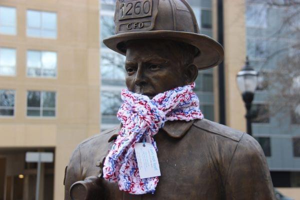 Fireman statue in West Side Park wearing one of Gretchen's scarves