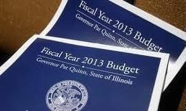 Copies of the 2013 Illinois State Budget are displayed. 