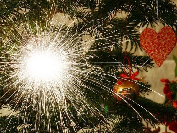 A sparkler as decoration on a christmas tree