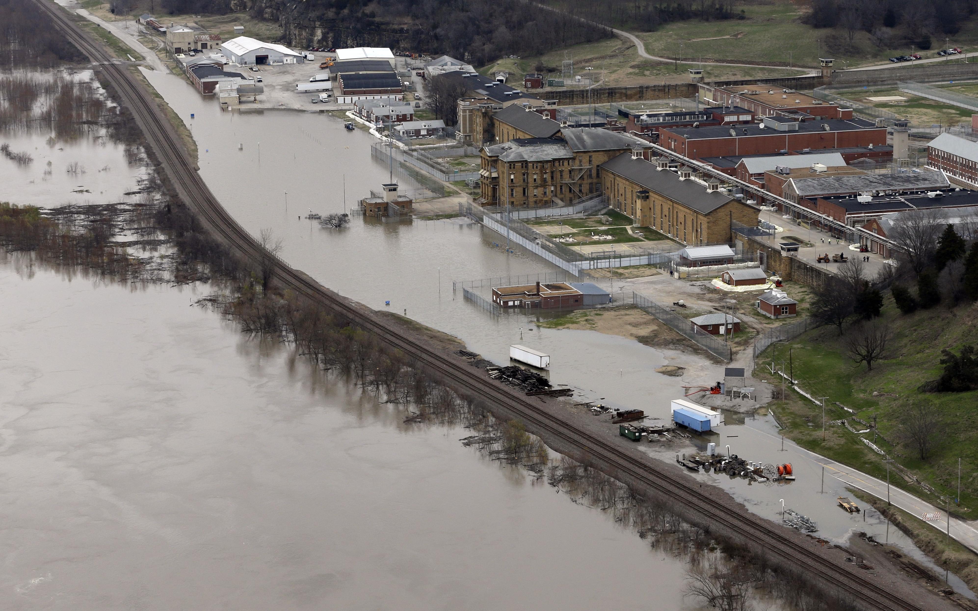 In this aerial photo, floodwater from the Mississippi River threatens the maximum security Menard Correctional Center, Thursday, Dec. 31, 2015, in Chester, Ill. Surging Midwestern rivers forced hundreds of evacuations, threatened dozens of levees and
