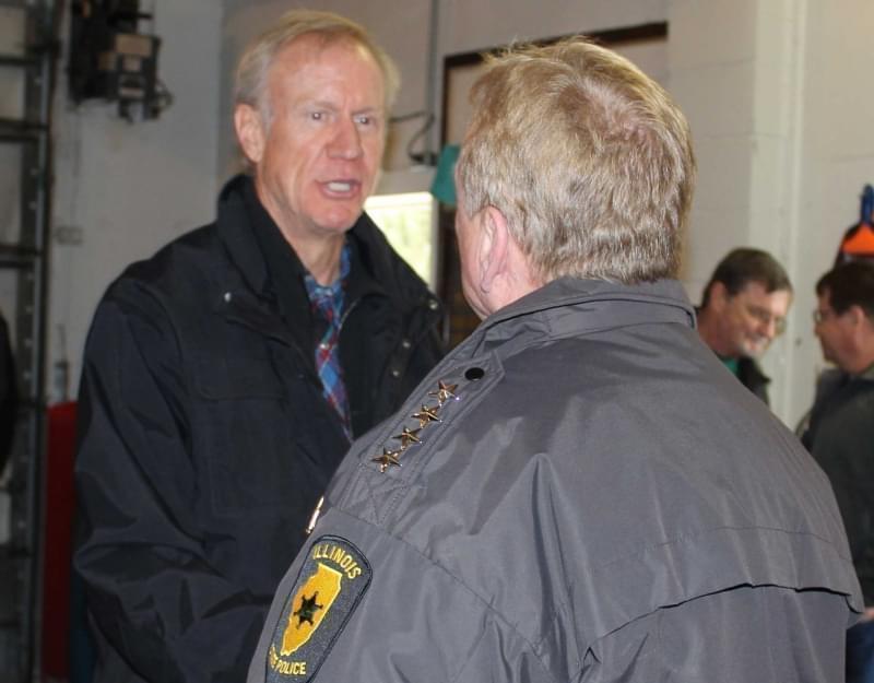 Rauner greets Illinois State Police Director Leo Schmitz at the Villa Grove Fire Station Sunday.