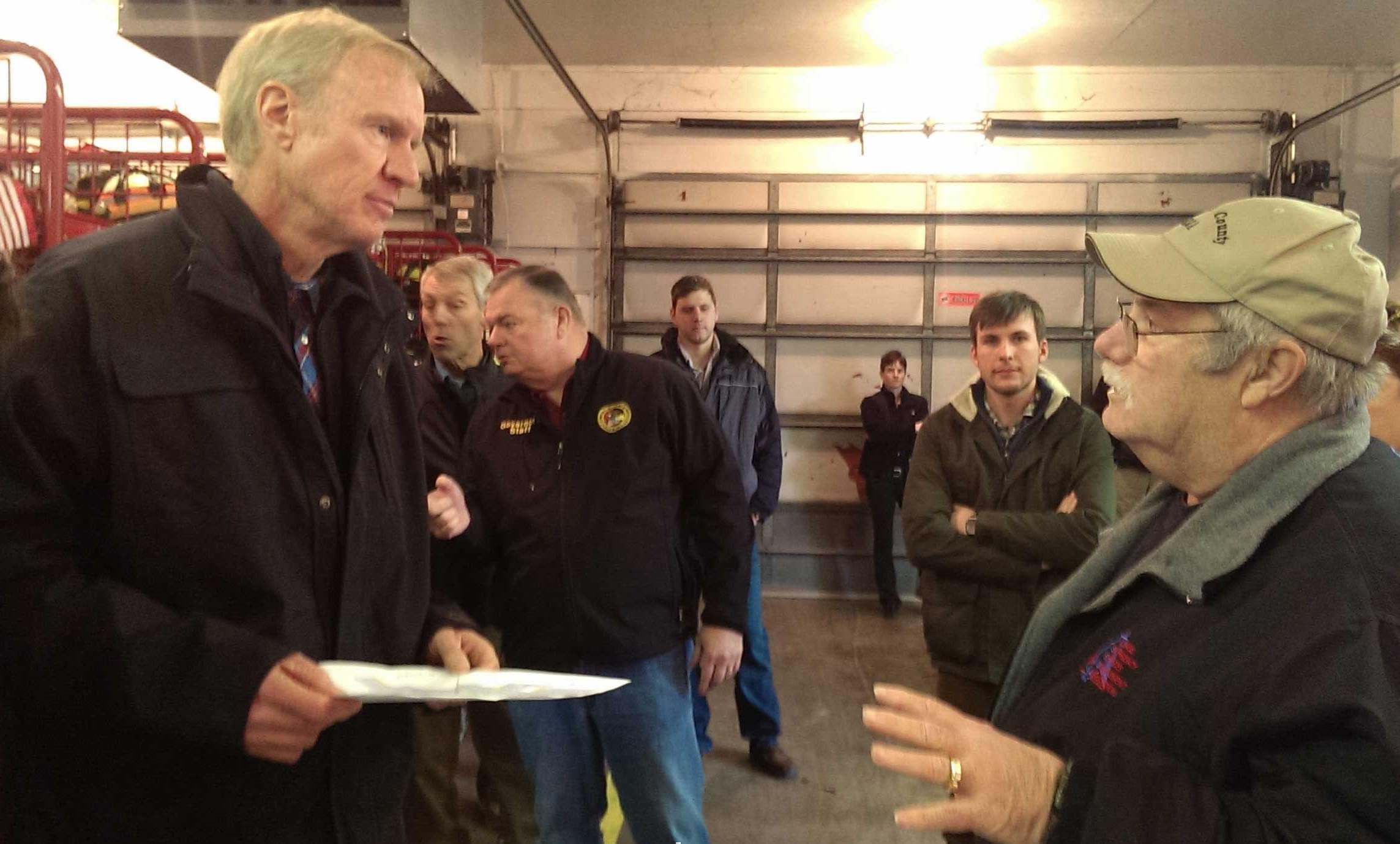 Gov. Bruce Rauner talking with Douglas County EMA Director Joseph Victor