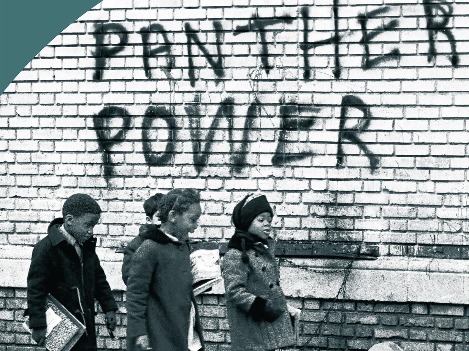 African American school children walk past spray painted sign which reads, "Panther Power"