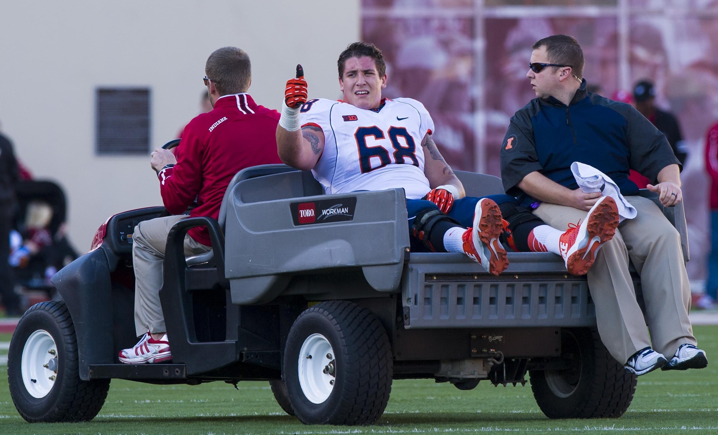 Illinois offensive linesman Simon Cvijanovic is taken from the field after being injured during an NCAA college football game