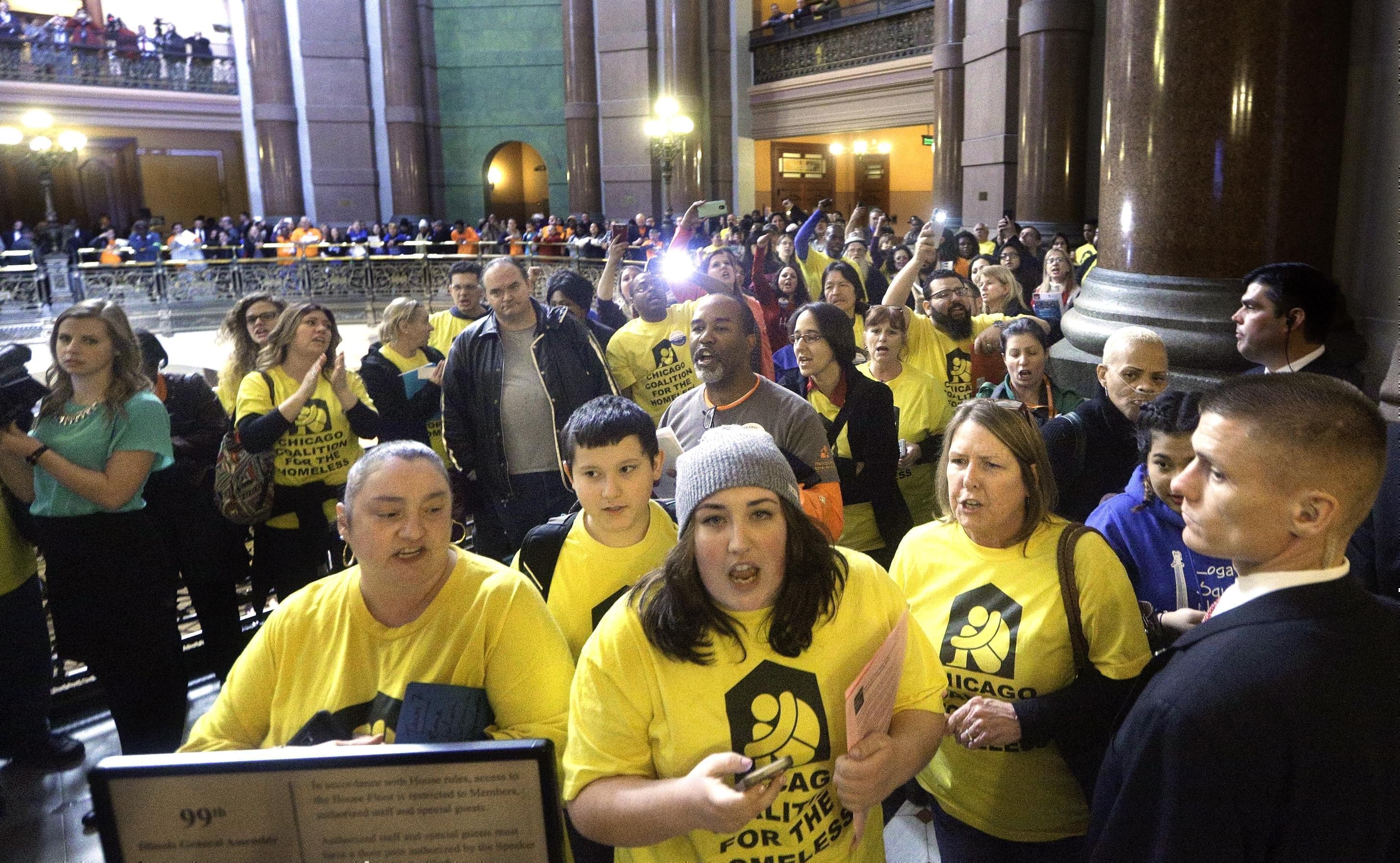 Protestors outside the House chamber while Illinois Gov. Bruce Rauner delivers his State of the State address