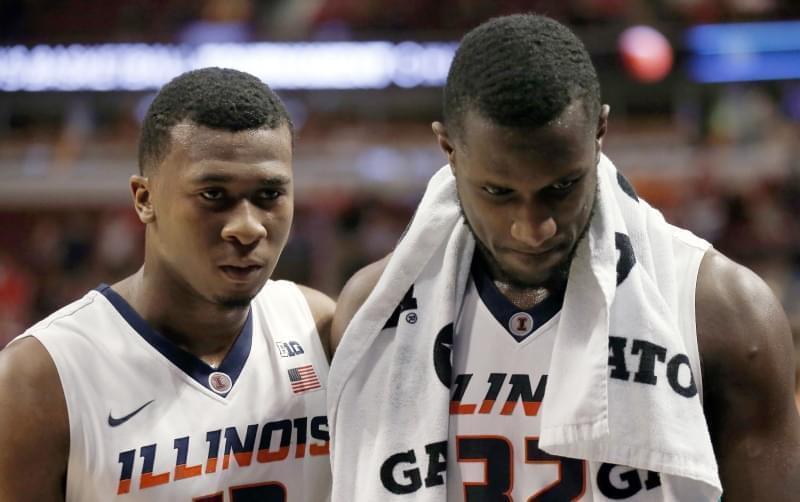 Illinois' Leron Black (12) and Nnanna Egwu (32) walk off the court after an NCAA college basketball game against Michigan in the second round of the Big Ten Conference tournament, Thursday, March 12, 2015, in Chicago. 