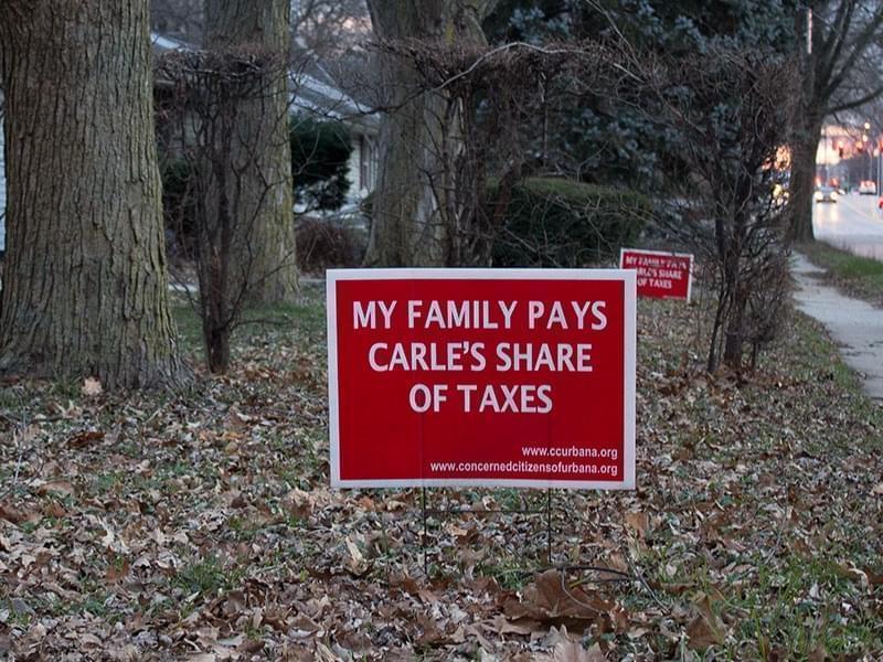 A sign in front of a home on Lincoln Avenue in Urbana protests Carle Hospital's tax-exempt status.