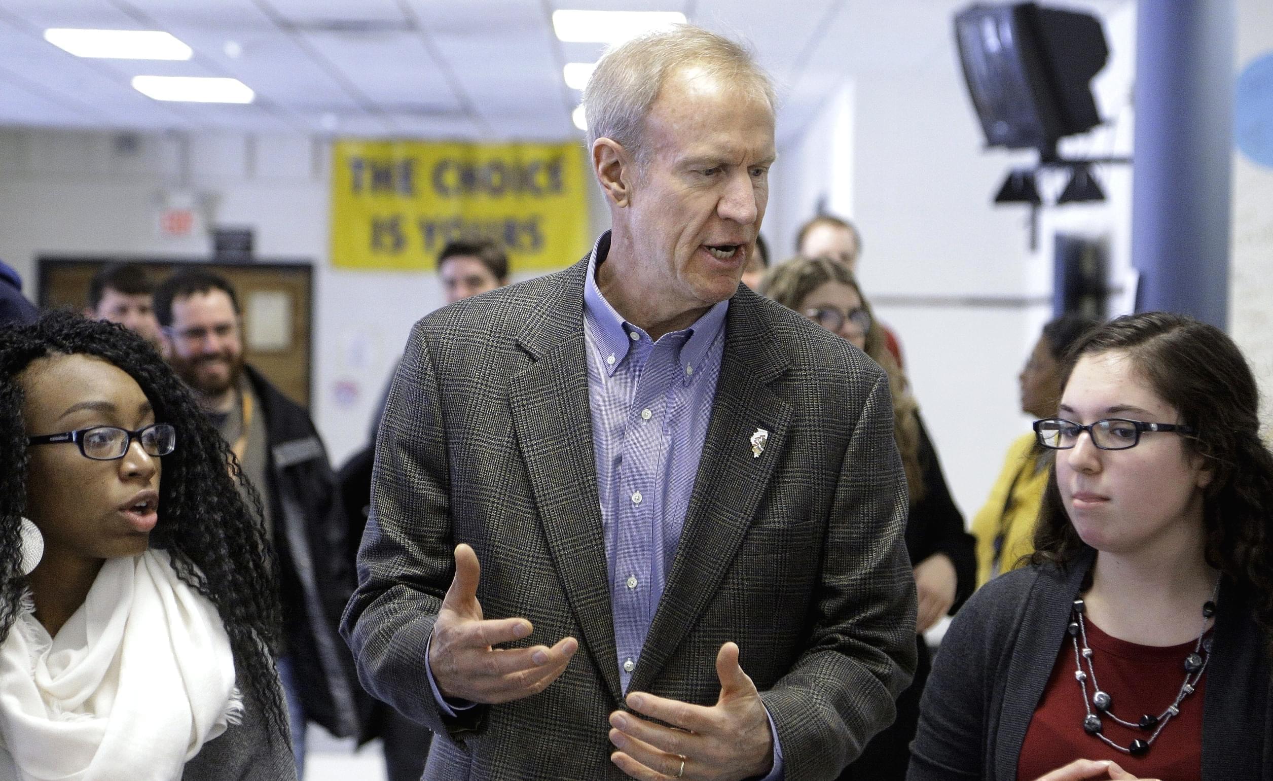 n this Feb. 24, 2016 photo, Illinois Gov. Bruce Rauner visits with students hoping to attend college during a visit to Southeast High School in Springfield, where he discussed his education agenda. 
