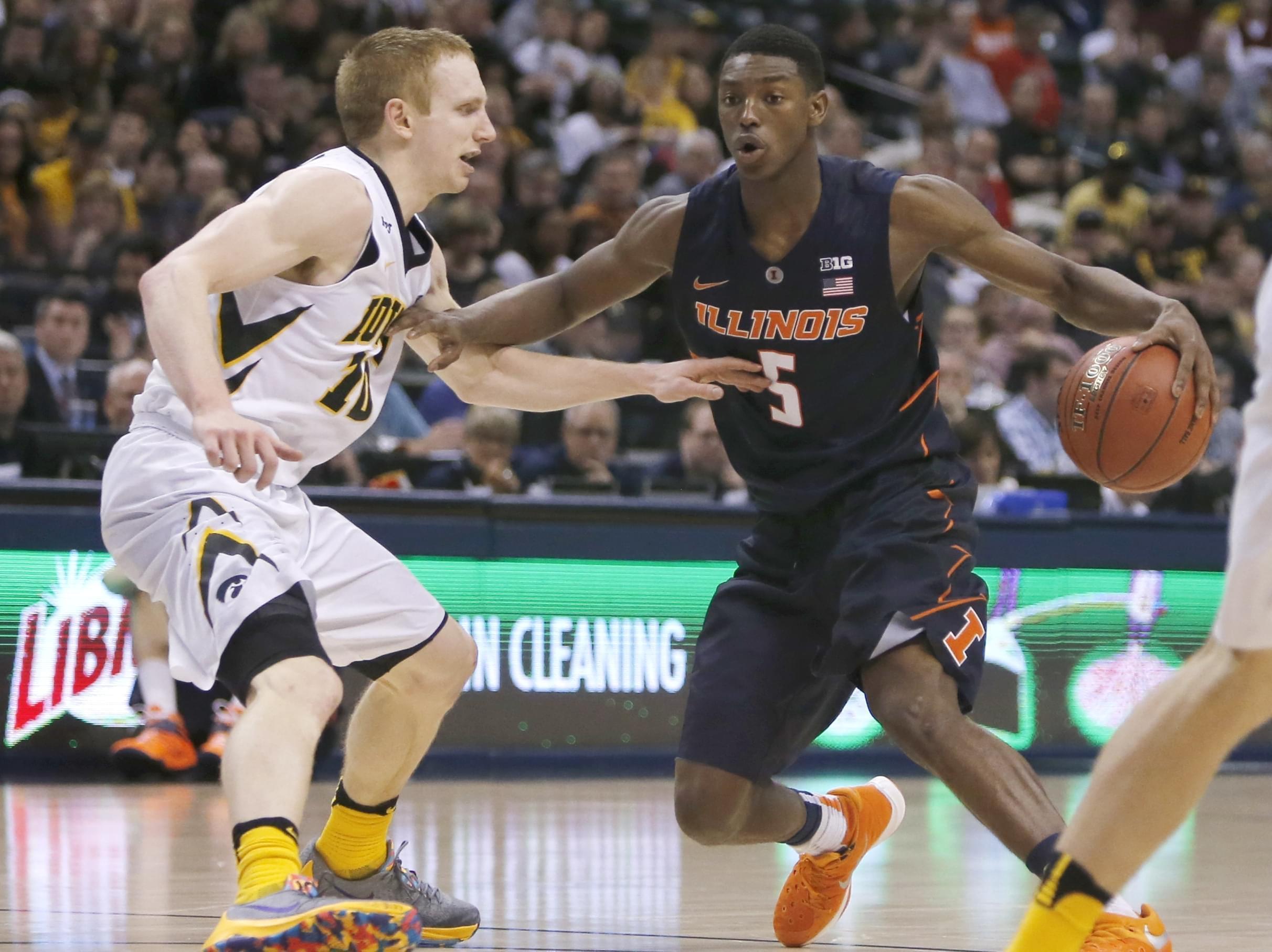 Illinois' Jalen Coleman-Lands (5) drives against Iowa's Mike Gesell (10) in the second half of an NCAA college basketball game at the Big Ten Conference tournament Thursday.