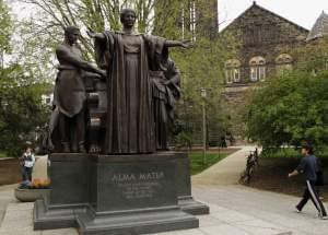 In this April 28, 2014 photo, students walk past the Alma Mater statue, a landmark on the University of Illinois campus in Urbana