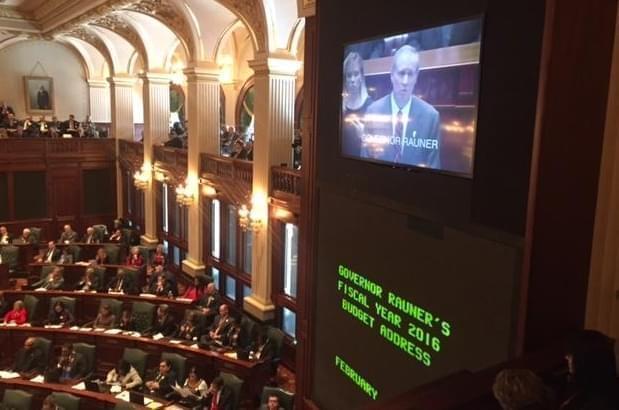 Gov. Bruce Rauner seen on a video monitor in the Illinois House chamber as he delivers a budget address.