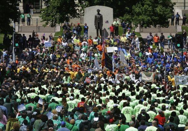 Union supporters rally against Republican Illinois Gov. Bruce Rauner's calls to change collective bargaining policies, in front of the Illinois State Capitol Wednesday, May 18, 2016, in Springfield, Ill. The march is organized by a coalition of 