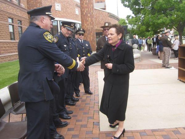 Illinois Supreme Court Chief Justice Rita Garman greets Parkland College Police Chief William Colbrook.