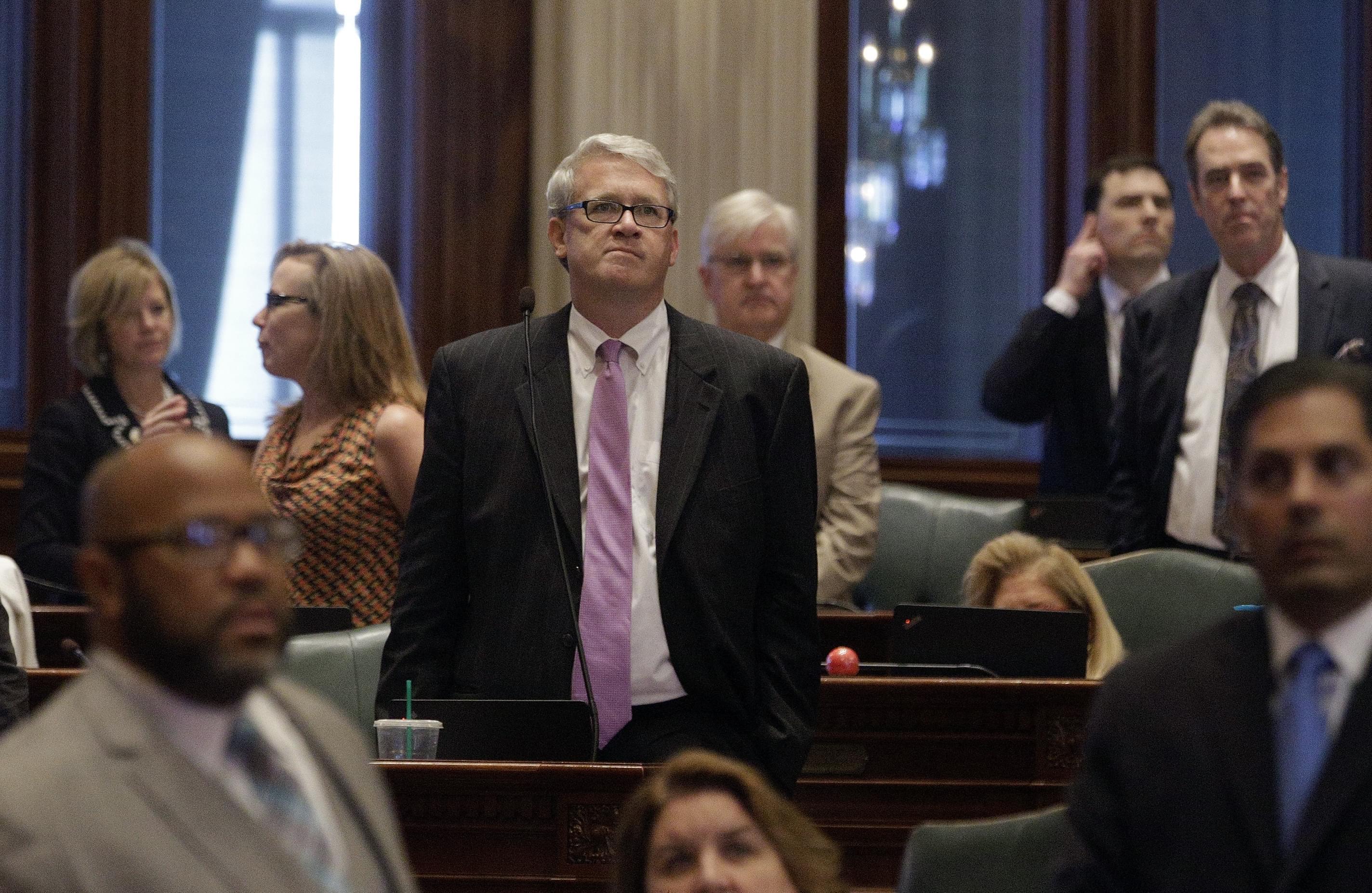 Illinois House Minority Leader Jim Durkin, R-Western Springs, center, listens to House Speaker Michael Madigan, D-Chicago, speaks to lawmakers at the state Capitol on Thursday, May 26, 2016, in Springfield.