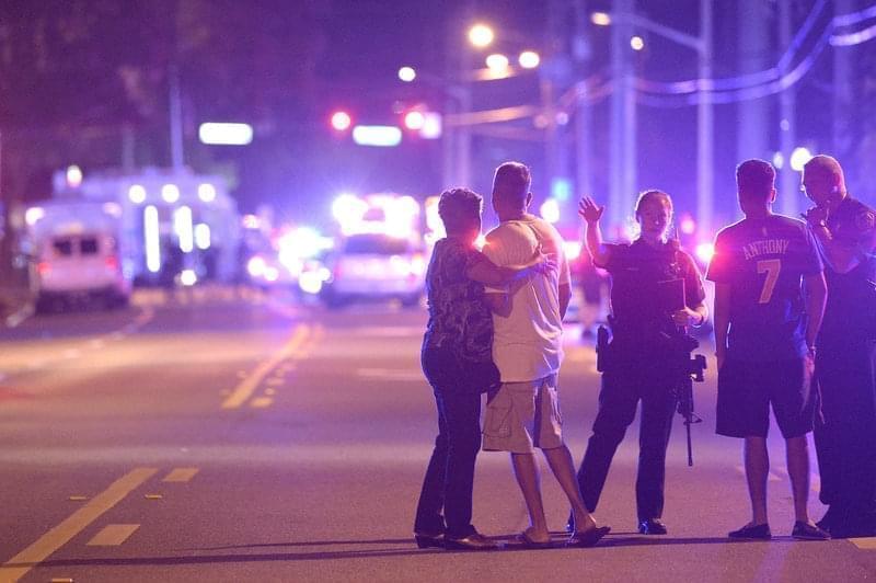 Orlando police officers direct family members away from a shooting at a nightclub in Orlando, Fla., on Sunday.