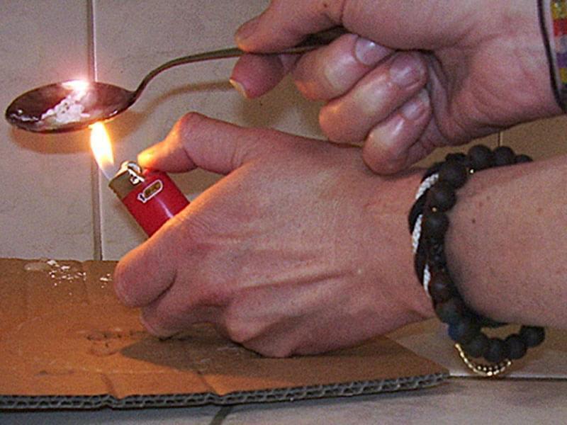 Heroin in a spoon with a lighter underneath
