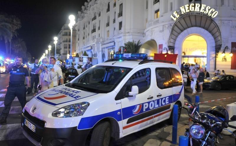 A Police car is parked near the scene of an attack after a truck drove on to the sidewalk and plowed through a crowd of revelers who'd gathered to watch the fireworks in the French resort city of Nice, southern France, Friday, July 15, 2016. A s