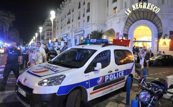A Police car is parked near the scene of an attack after a truck drove on to the sidewalk and plowed through a crowd of revelers who'd gathered to watch the fireworks in the French resort city of Nice, southern France, Friday, July 15, 2016. A s