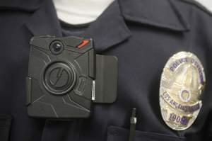 In this Jan. 15, 2014 file photo, a Los Angeles Police officer wears an on-body camera during a demonstration in Los Angeles. 