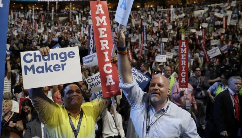 Illinois delegate Sunil Puri and supporter Jon Pyatt cheer during the second day session of the Democratic National Convention in Philadelphia.