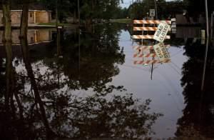 Standing water closes roads in Sorrento, La., Saturday, Aug. 20, 2016. Louisiana continues to dig itself out from devastating floods, with search parties going door to door looking for survivors or bodies trapped by flooding.