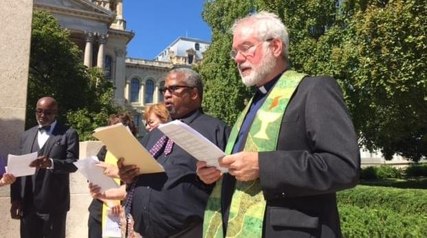Rev. Booker Vance of Faith in Place and Rev. Martin Woulfe of the Abraham Lincoln Unitarian Universalist Congregation in Springfield, sing at the end of the Moral Monday rally.