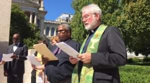 Rev. Booker Vance of Faith in Place and Rev. Martin Woulfe of the Abraham Lincoln Unitarian Universalist Congregation in Springfield, sing at the end of the Moral Monday rally.
