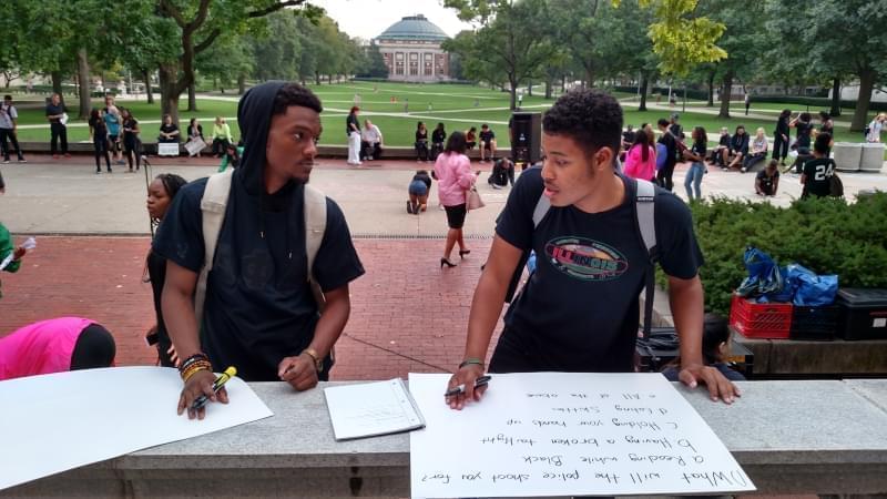 Undergraduate students Immanuel Campbell and Marques Webster create signs during a "Call To Action" event on the University of Illinois Main Quad on Sunday, September 25, 2016.