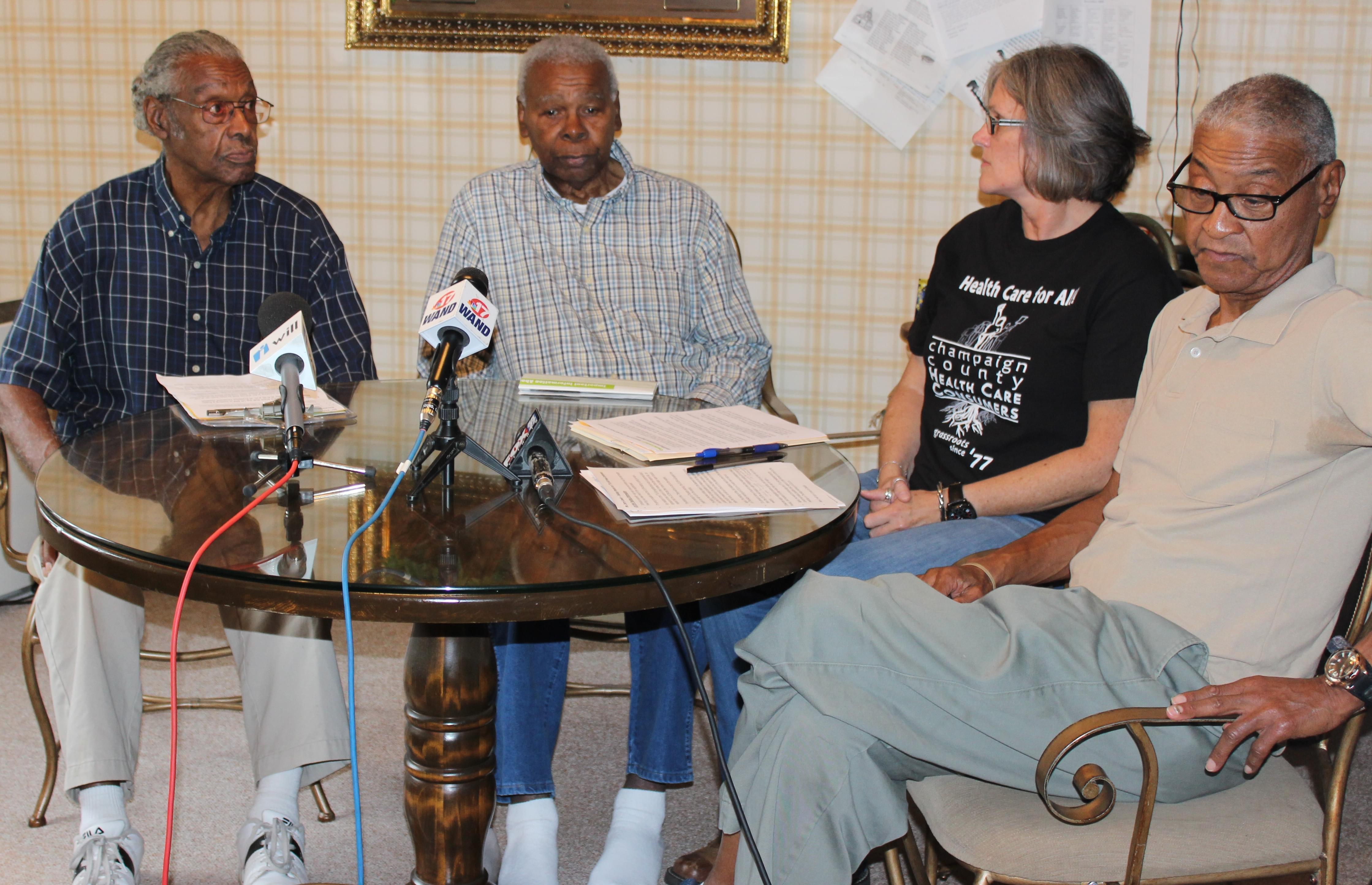 5th and Hill neighborhood residents M.D. Pelmore, Ebbie Cook, and Jerry Lewis meet with Claudia Lennhoff of Champaign County Health Care Consumers Tuesday at Pelmore's home in Champaign