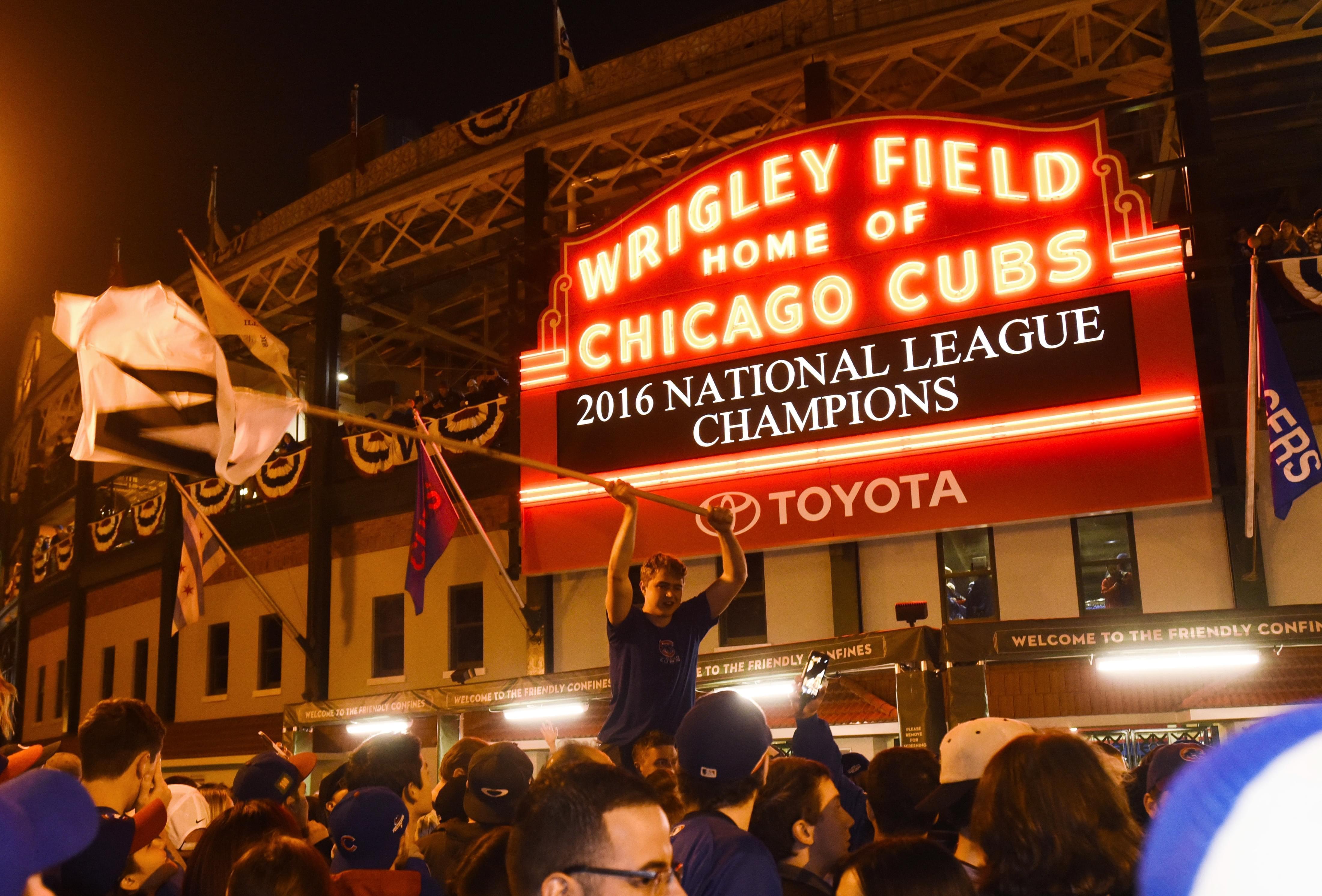 Chicago Cubs fans celebrate outside Wrigley Field after the Cubs defeated the Los Angeles Dodgers 5-0 in Game 6 of baseball's National League Championship Series, Saturday, Oct. 22, 2016, in Chicago. The Cubs advanced to the World Series.