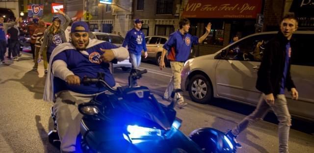 Cubs fans celebrate on Clark Street after the team won the National League Championship Series Saturday night.